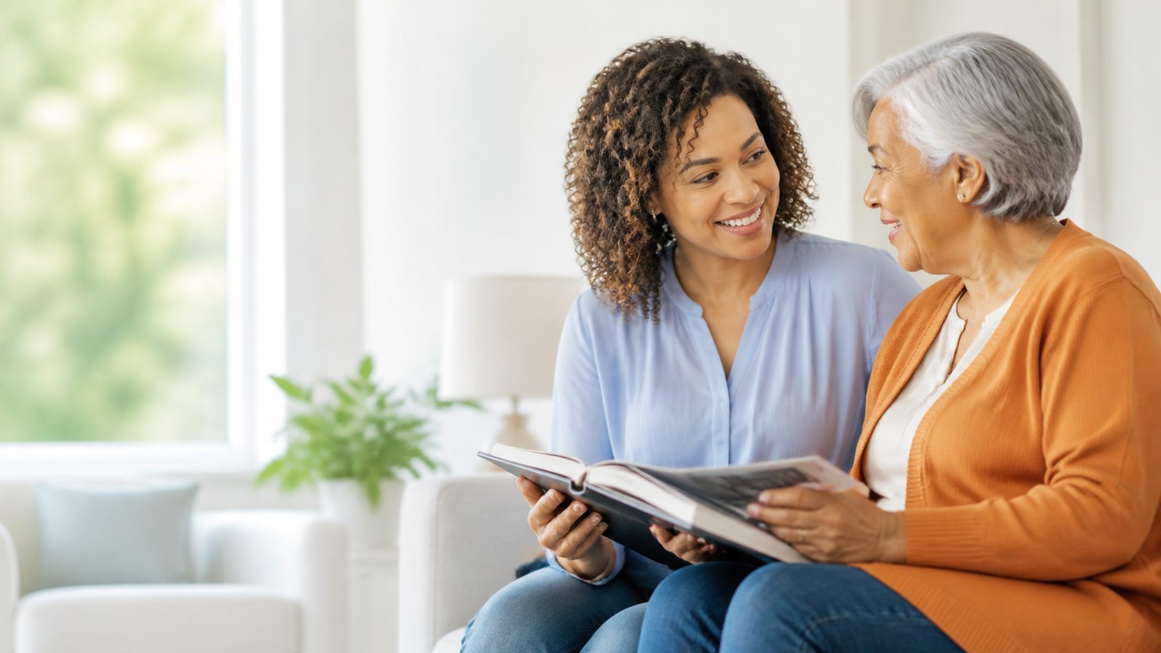 A caregiver and older adult sharing a photo album at home